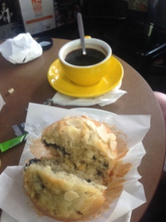 1/2 blueberry muffin 1/2 banana muffin and a cwoffee
